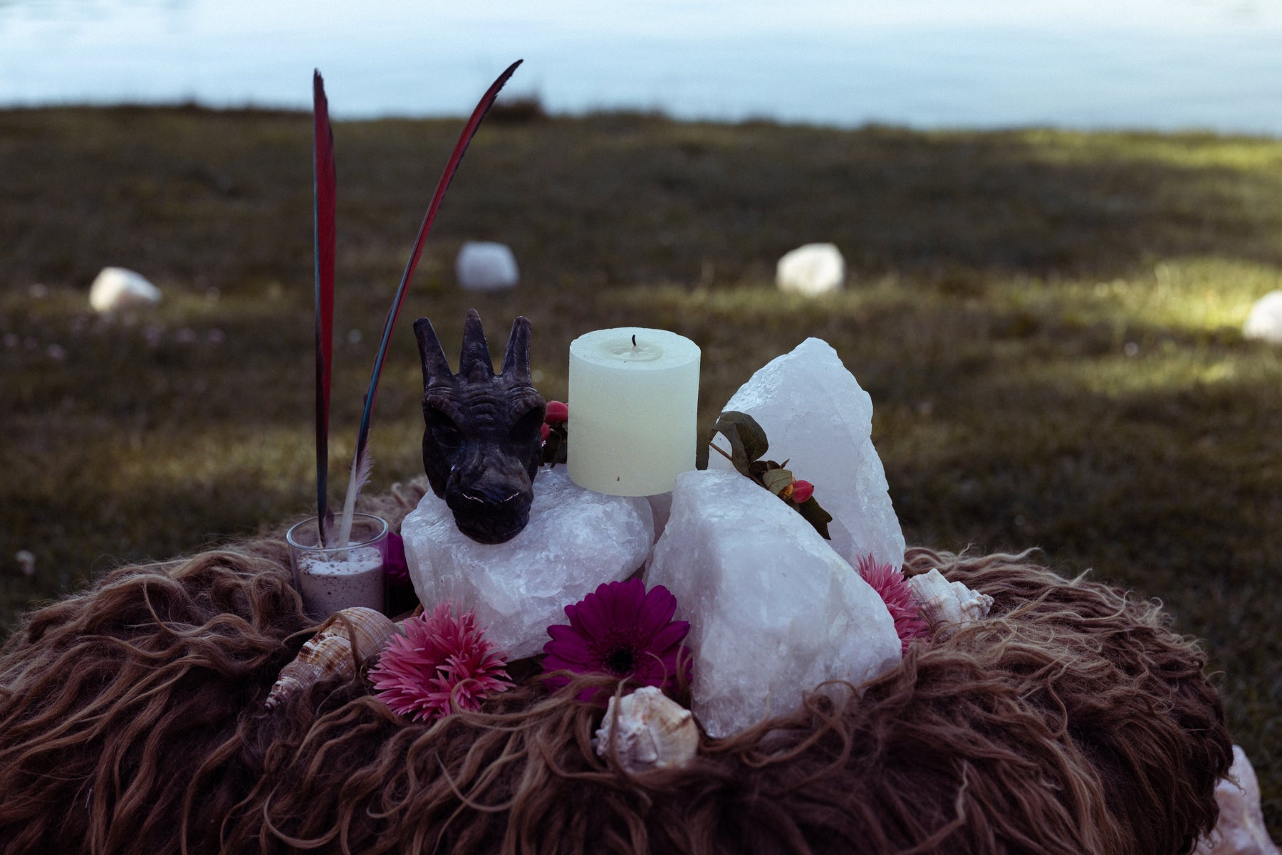 Spiritual altar with feather, dragon and stones in there forest