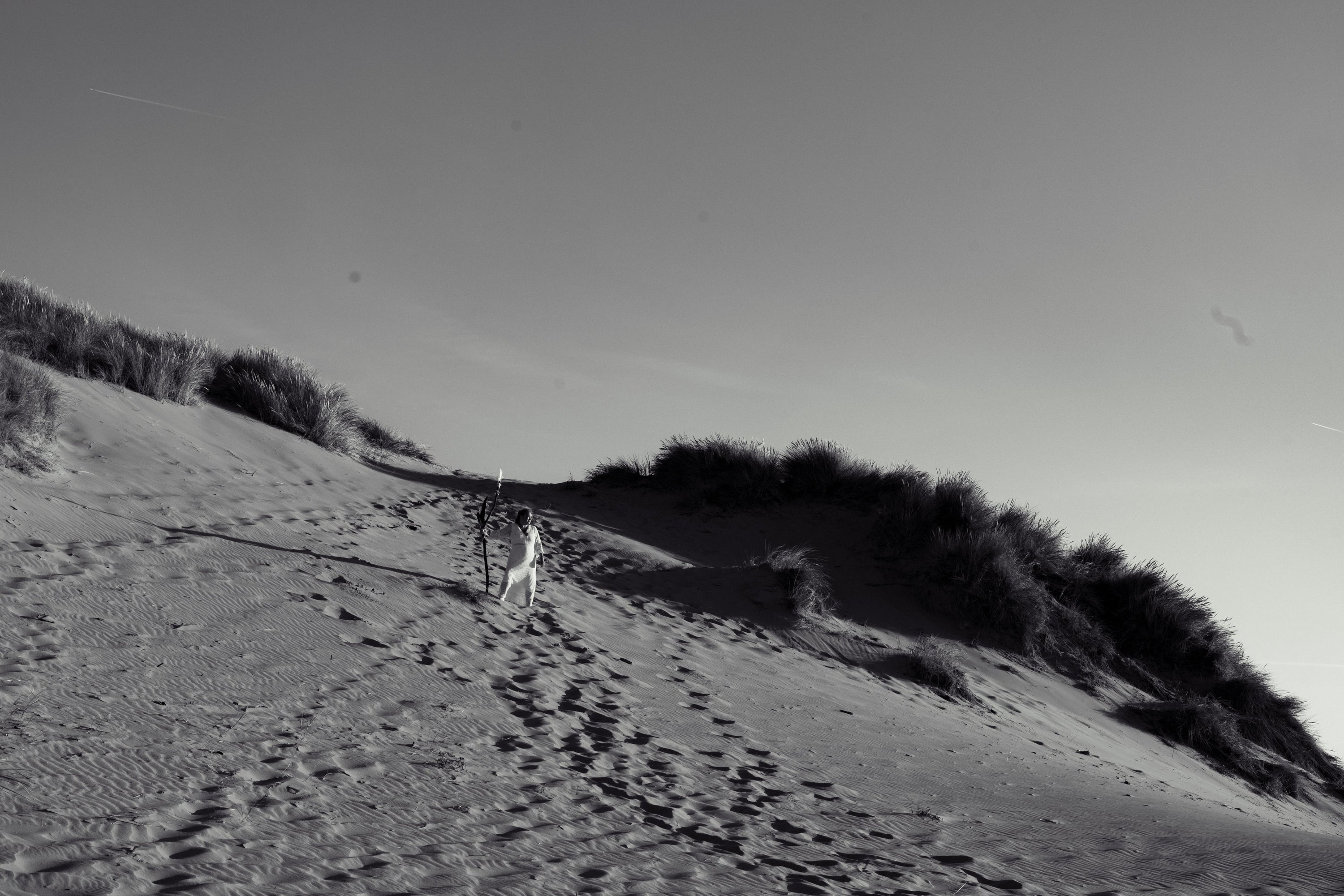 Spiritual Woman on the beach with a wouden staff