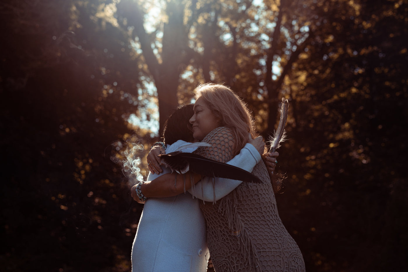 Spiritual woman hugging in the forest